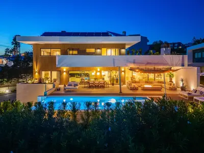 a house with a swimming pool at night at Luxury Beach Villa - Casa do Forte- Infinity Pool sea view- Beach walking distance by DreamvillasAlbufeira in Albufeira