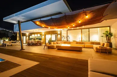 a living room with couches and tables and lights at Luxury Beach Villa - Casa do Forte- Infinity Pool sea view- Beach walking distance by DreamvillasAlbufeira in Albufeira