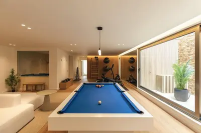a living room with a pool table at Luxury Beach Villa - Casa do Forte- Infinity Pool sea view- Beach walking distance by DreamvillasAlbufeira in Albufeira