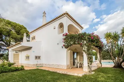 a white church with a garden and a pool at Falesia by Check-in Portugal in Albufeira