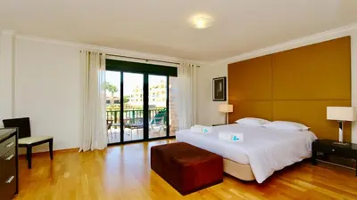 a bedroom with a large bed and a large window at Los Olivos Del Golf 249- CleverDetails, Sleeps 6 Adults 1 Child in Vilamoura