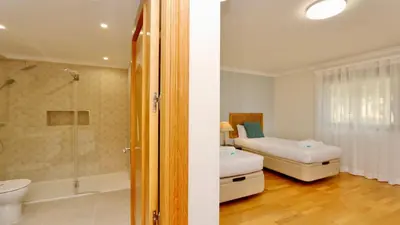 a bathroom with a bed and a shower and a toilet at Los Olivos Del Golf 249- CleverDetails, Sleeps 6 Adults 1 Child in Vilamoura
