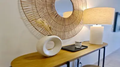 a vase on a table with a lamp and a mirror at Los Olivos Del Golf 249- CleverDetails, Sleeps 6 Adults 1 Child in Vilamoura