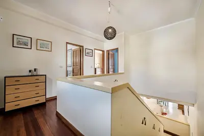 a kitchen with a staircase in the middle of a room at Villa Almanda - Spacious villa perfectly located between Albufeira Marina and the Old Town in Albufeira