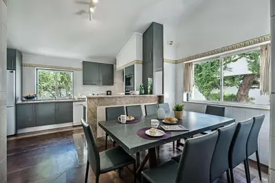 a dining room with a table and chairs in a kitchen at Villa Almanda - Spacious villa perfectly located between Albufeira Marina and the Old Town in Albufeira