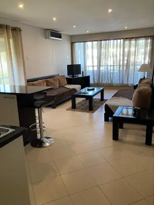 a living room with a couch and a table at Vilamoura Apartamento Algarve 311 in Vilamoura