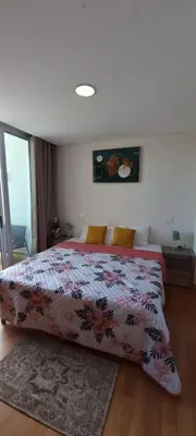 a bedroom with a bed with a floral bedspread at Star Dreams Albufeira in Albufeira
