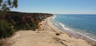 a beach with many chairs and umbrellas and people at Maré Alta by CS in Olhos de Água