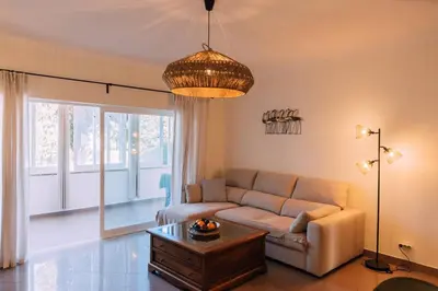a living room with a couch and a table at Starry Nights Apartment in Albufeira
