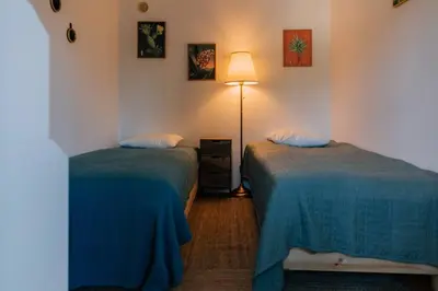 a room with two beds and a lamp in it at Starry Nights Apartment in Albufeira