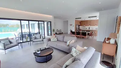a living room with couches and a table and a kitchen at Valverde 3 Villa, Vilamoura, Algarve, only 5 minutes from Marina, Golf and Beach in Quarteira