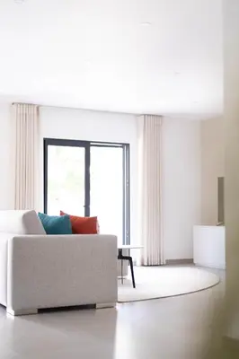 a living room with a couch and a window at Orange Boutique Residence - Casa Luis Camões in Quarteira