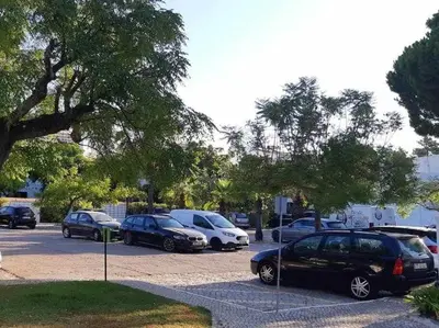 a group of cars parked in a parking lot at Green House by FHR estacionamento e WI-FI in Quarteira