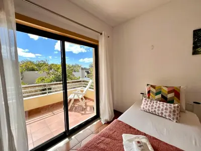 a living room with a couch and a table at Albufeira Experience With Pool by Homing in Albufeira