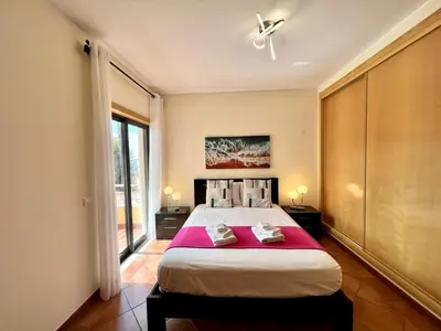 a bedroom with a large bed with two towels on it at Albufeira Experience With Pool by Homing in Albufeira