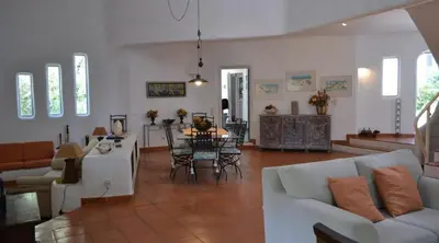 a living room with a couch and a table at Villa Pinhal- Beautiful Villa located in quiet area in Quarteira