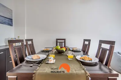 a dining room table with plates of food on it at #123 T2 Pão das Areias by Home Holidays in Albufeira