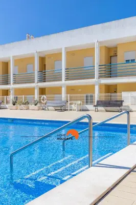 a swimming pool in front of a hotel at #123 T2 Pão das Areias by Home Holidays in Albufeira