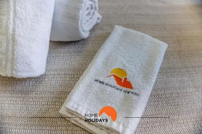 a pair of towels sitting on top of a bed at #123 T2 Pão das Areias by Home Holidays in Albufeira