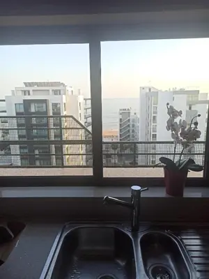 a kitchen sink with a view of the ocean at Divine Quarteira Sea View By JG Apartments in Quarteira