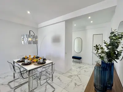 a white living room with a table and chairs at Faro Deluxe by Homing in Faro