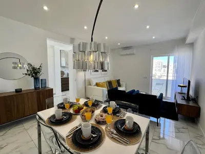 a living room with a table with plates of food at Faro Deluxe by Homing in Faro