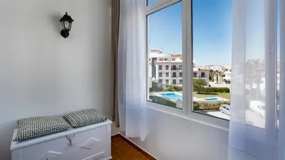 a white window with a view of a building at Sun-kissed Oasis W/ Pool by LovelyStay in Albufeira