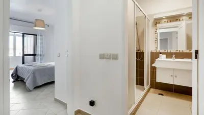 a bathroom with a sink and a bed in a room at Sun-kissed Oasis W/ Pool by LovelyStay in Albufeira