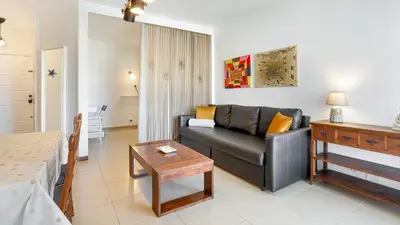a living room with a couch and a table at Sun-kissed Oasis W/ Pool by LovelyStay in Albufeira