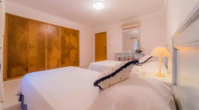 a bedroom with two white beds and a lamp at Villa Bonsal - Modern villa in a prime location near the luxury golf courses in Albufeira