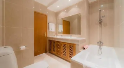 a bathroom with a sink and a toilet and a mirror at Villa Bonsal - Modern villa in a prime location near the luxury golf courses in Albufeira