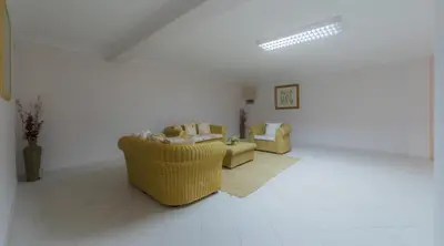 a living room with two chairs and a couch at Villa Bonsal - Modern villa in a prime location near the luxury golf courses in Albufeira