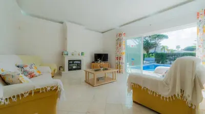 a living room with two couches and a tv at Villa Bonsal - Modern villa in a prime location near the luxury golf courses in Albufeira