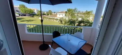 a view of a balcony with an umbrella and a table at Baia Village - Galé - Albufeira in Albufeira