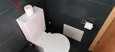 a bathroom with a white toilet with two rolls of toilet paper at Baia Village - Galé - Albufeira in Albufeira