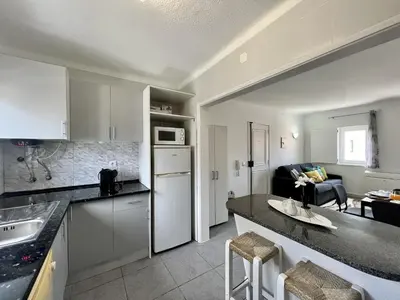 a kitchen and living room with a counter top at Vilamoura Central 5 by Homing in Vilamoura