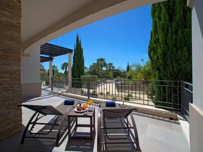 a patio with a table and chairs on a balcony at Apartment Pine Hills Turquesa by Interhome in Vilamoura