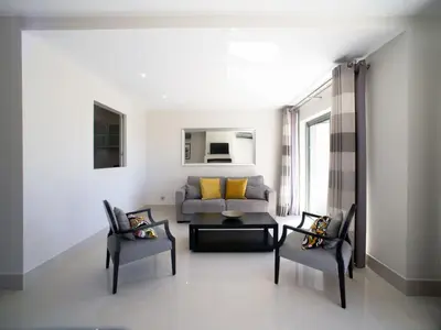 a living room with a couch and two chairs at Apartment Pine Hills Turquesa by Interhome in Vilamoura
