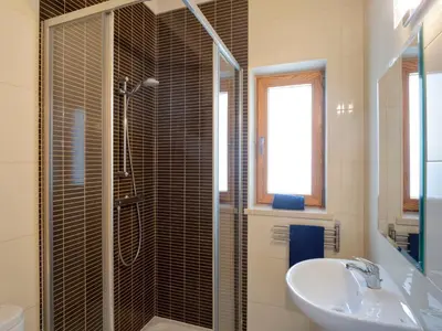 a bathroom with a sink and a glass shower at Villa Mathilda by Interhome in Albufeira