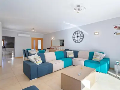 a living room with a blue and white couch at Villa Mathilda by Interhome in Albufeira