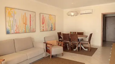 a living room with a couch and a table and chairs at Your house at Falésia in Albufeira