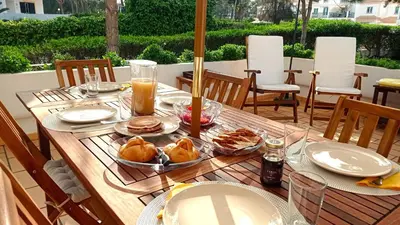 a table with food and drinks on a patio at Your house at Falésia in Albufeira