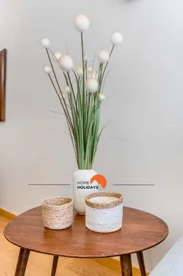 a table with a vase with white flowers on it at #032 T2 Idalia by Home Holidays in Albufeira