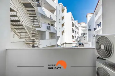 a view of two tall white buildings with a fan at #032 T2 Idalia by Home Holidays in Albufeira