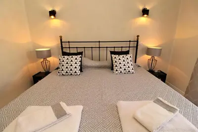 a bedroom with a large bed with two lamps at Ocean View Hydrangea - 2 Bedroom Apartment at São Rafael Beach, Albufeira in Albufeira
