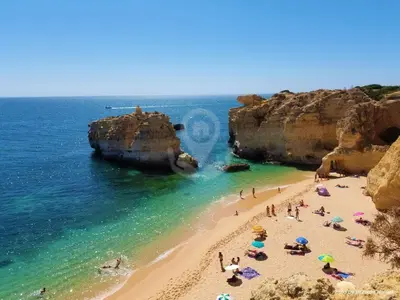a group of people on a beach near the ocean at Ocean View Hydrangea - 2 Bedroom Apartment at São Rafael Beach, Albufeira in Albufeira