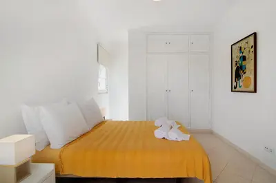 a bedroom with a bed with a stuffed animal on it at Villa Galé in Guia