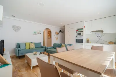 a kitchen and living room with a table and a couch at BeGuest Falésia Pine & Sun Apartment in Albufeira