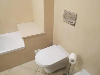 a bathroom with a white toilet and a sink at Apartamento - CERRO MAR in Albufeira