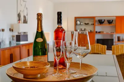 two bottles of wine and two glasses on a table at Apartamento Valerie in Vilamoura